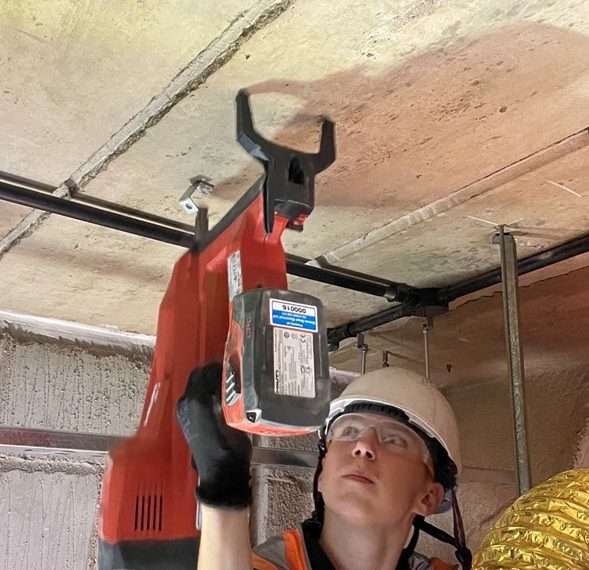 electrical contractor with reduced hand arm vibration using shot fire tool Hiliti